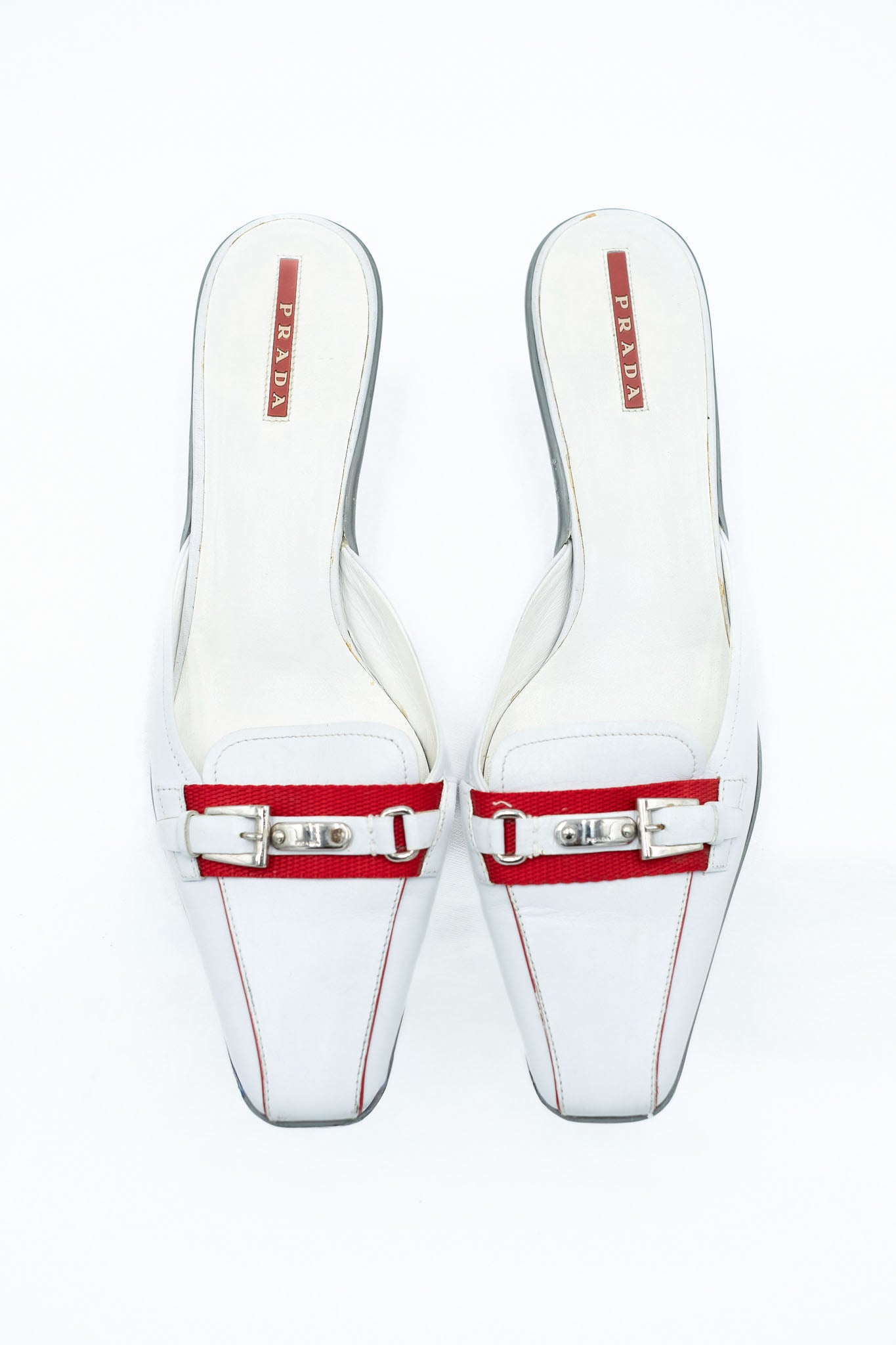 Prada white leather mules with red detail