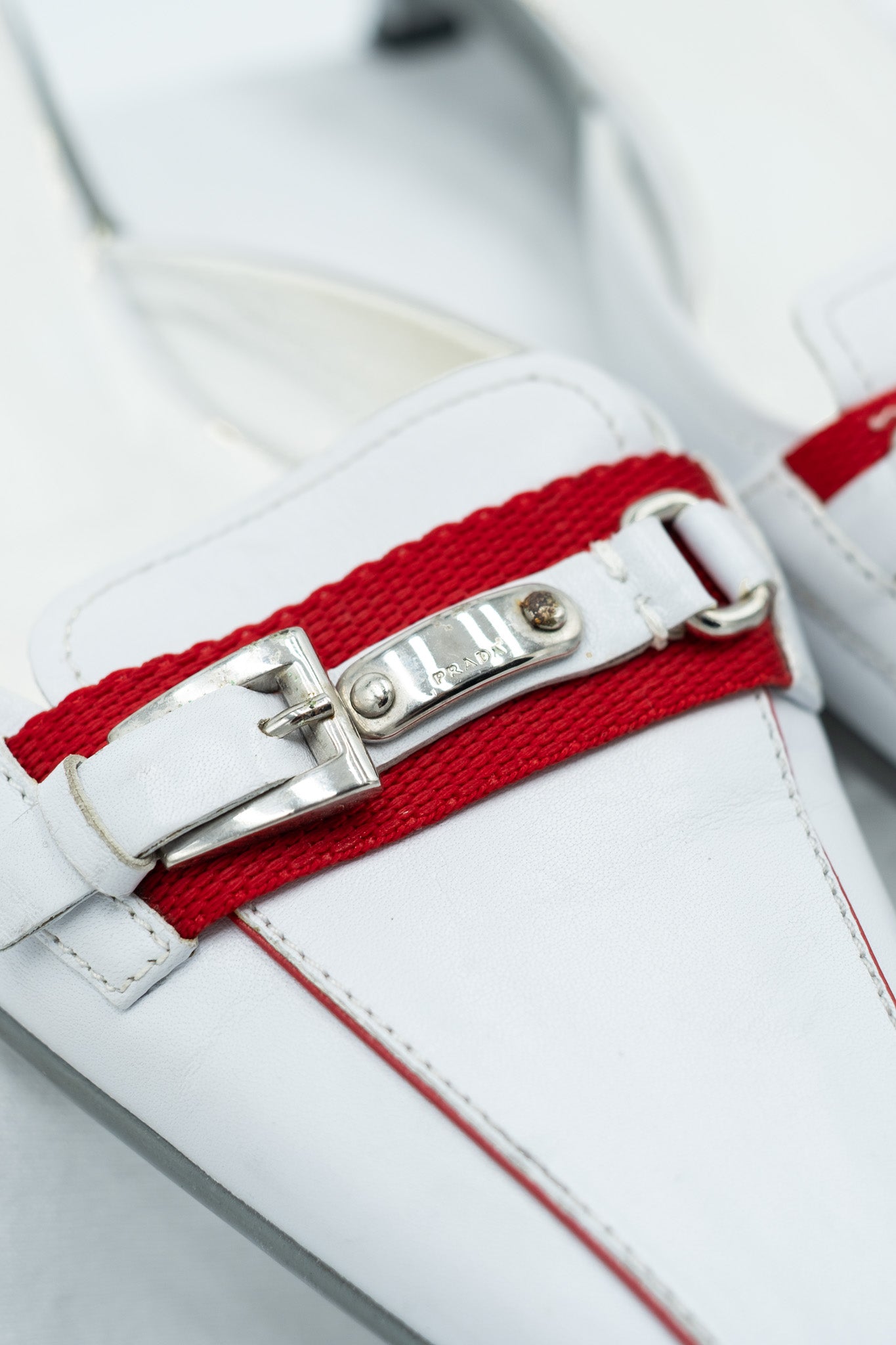 Prada white leather mules with red detail